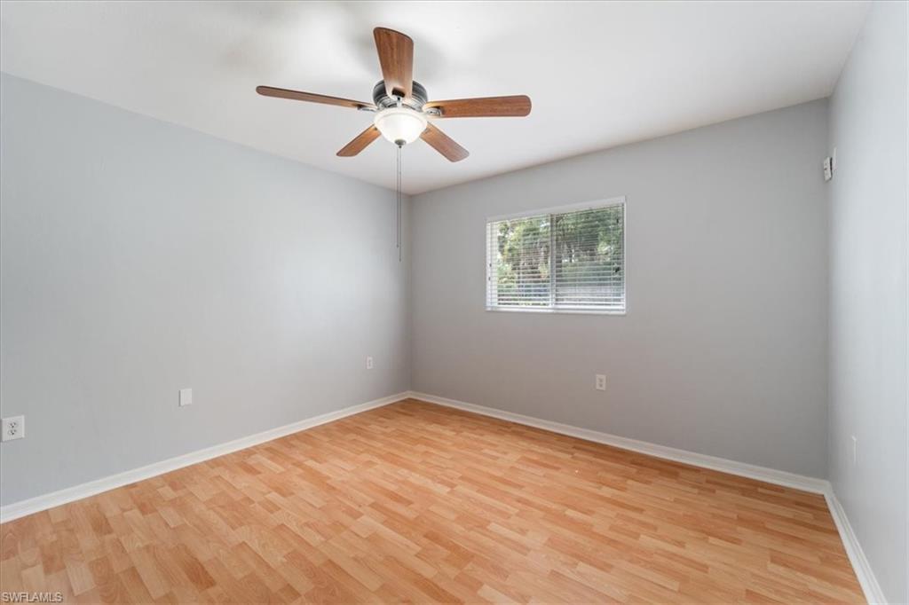 1161 25th Street Southwest Naples, FL 34117 - Photo 13 of 23 wooden floor in an empty room with a window