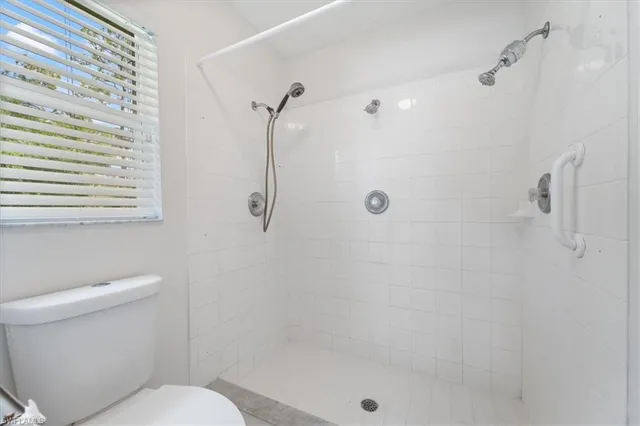 a bathroom with a shower and a toilet