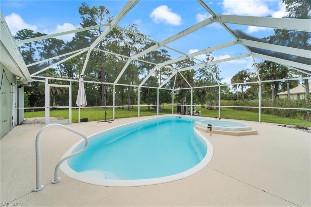 1161 25th Street Southwest Naples, FL 34117 - Photo 17 of 23 a view of a house with a backyard and a tub