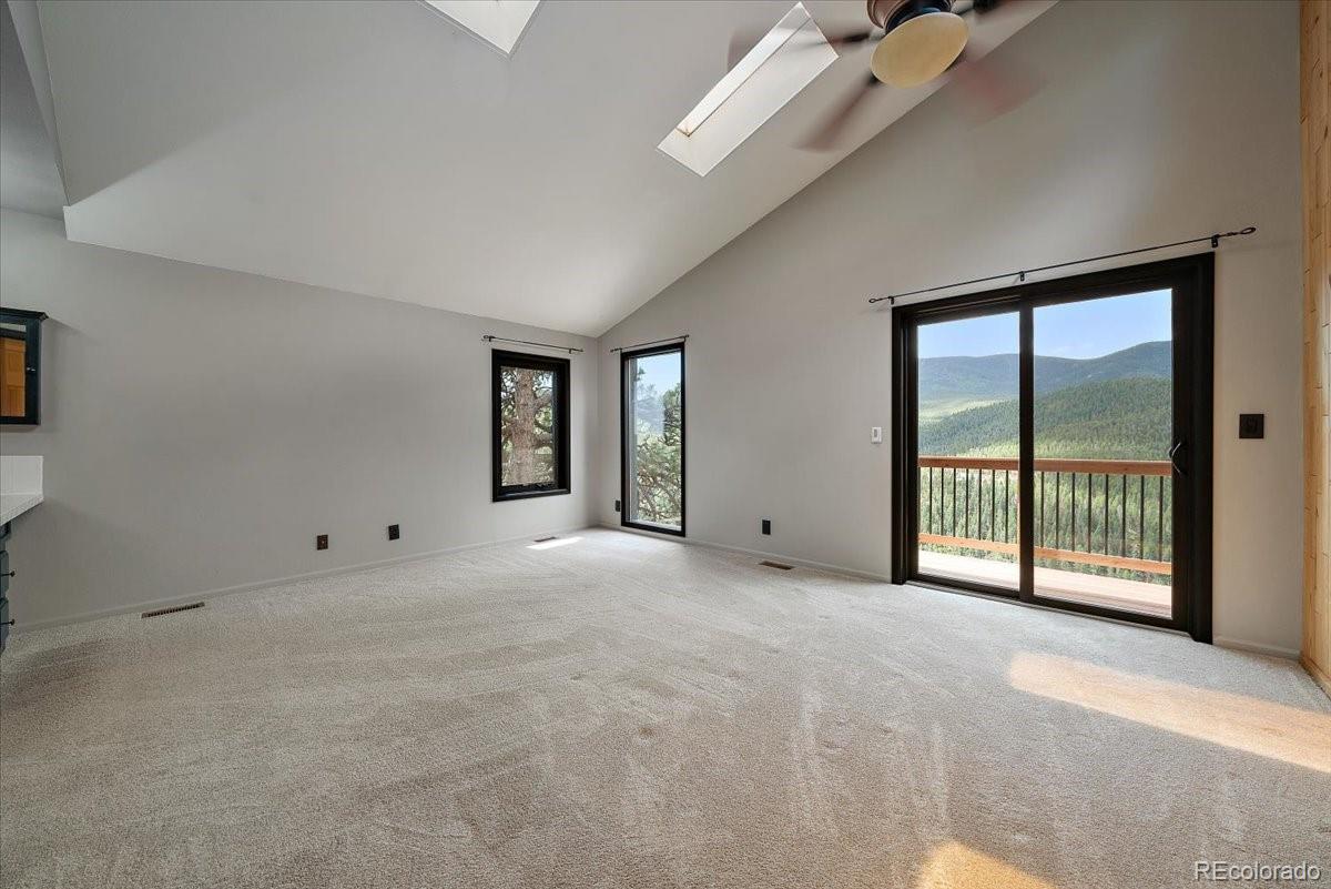 32482 Lodgepole Drive Evergreen, CO 80439 - Photo 14 of 40 a view of an empty room with a balcony