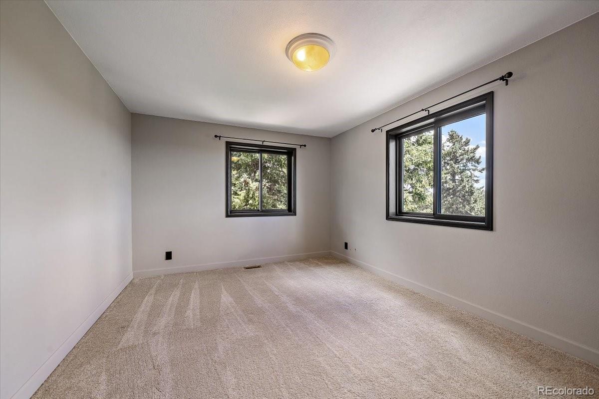 32482 Lodgepole Drive Evergreen, CO 80439 - Photo 21 of 40 an empty room with windows