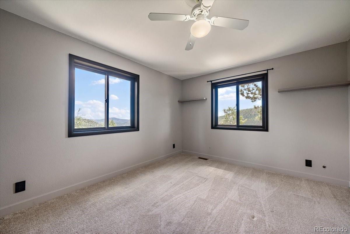 32482 Lodgepole Drive Evergreen, CO 80439 - Photo 22 of 40 a view of an empty room with a window