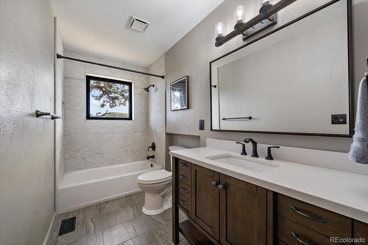 32482 Lodgepole Drive Evergreen, CO 80439 - Photo 23 of 40 a bathroom with a sink a toilet a shower and a mirror
