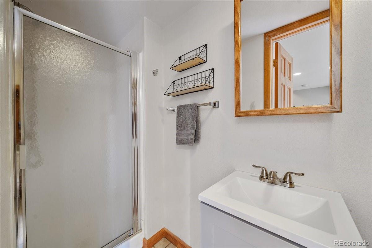 32482 Lodgepole Drive Evergreen, CO 80439 - Photo 27 of 40 a bathroom with a sink and a mirror