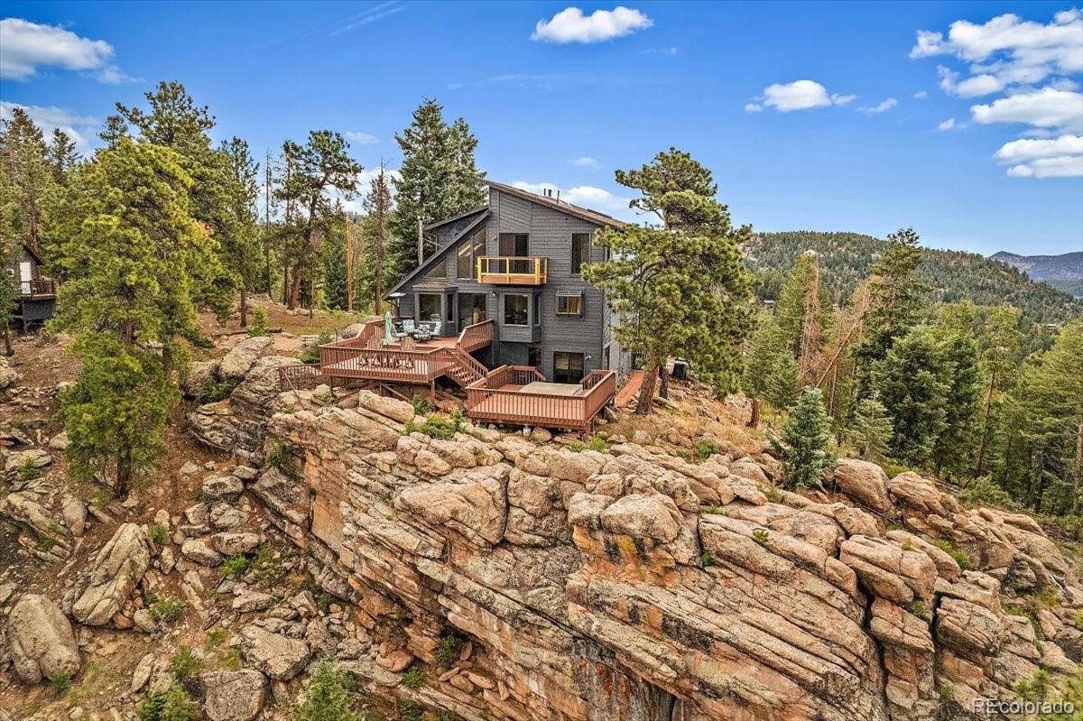 32482 Lodgepole Drive Evergreen, CO 80439 - Photo 28 of 40 a view of a house with a yard