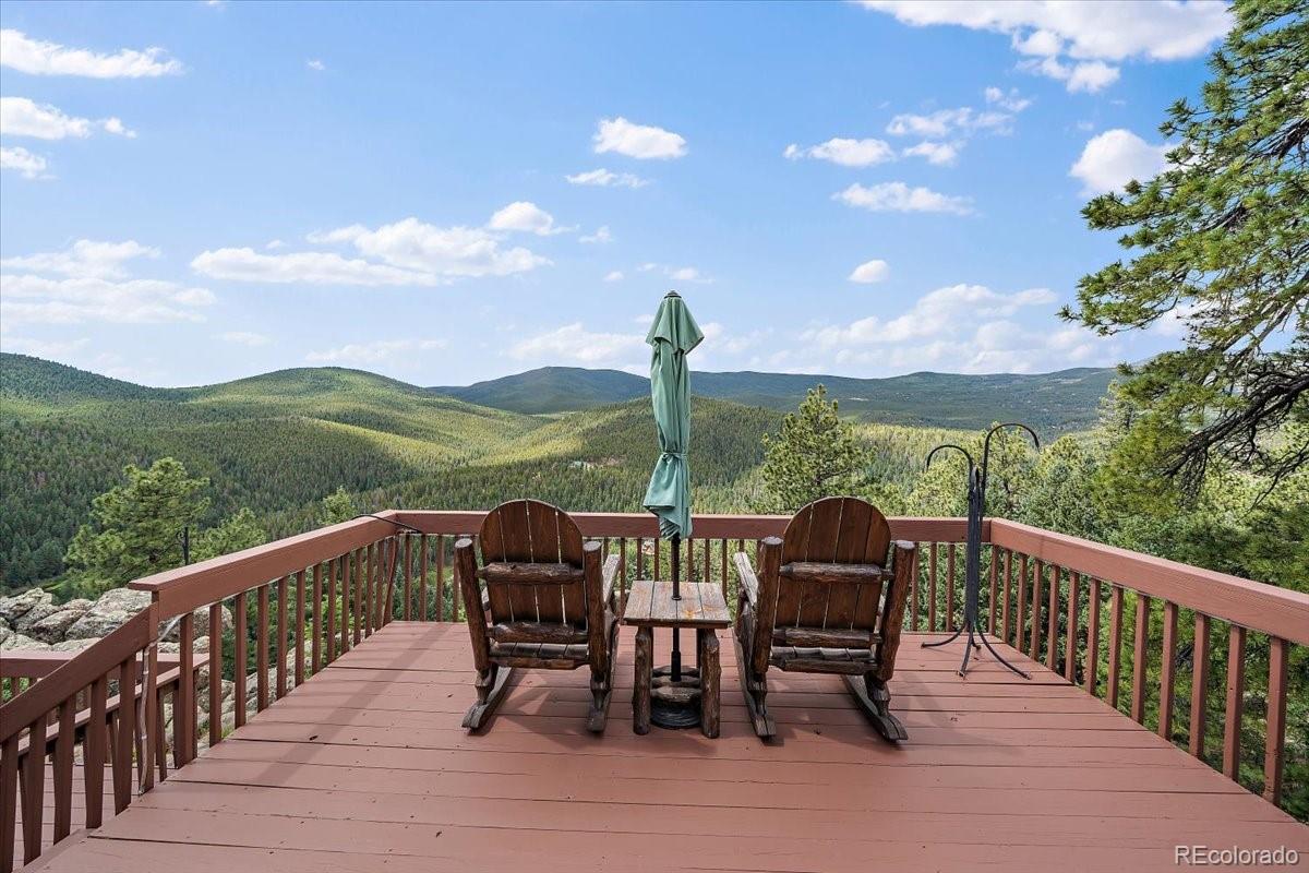 32482 Lodgepole Drive Evergreen, CO 80439 - Photo 30 of 40 a view of a chairs and table in the balcony