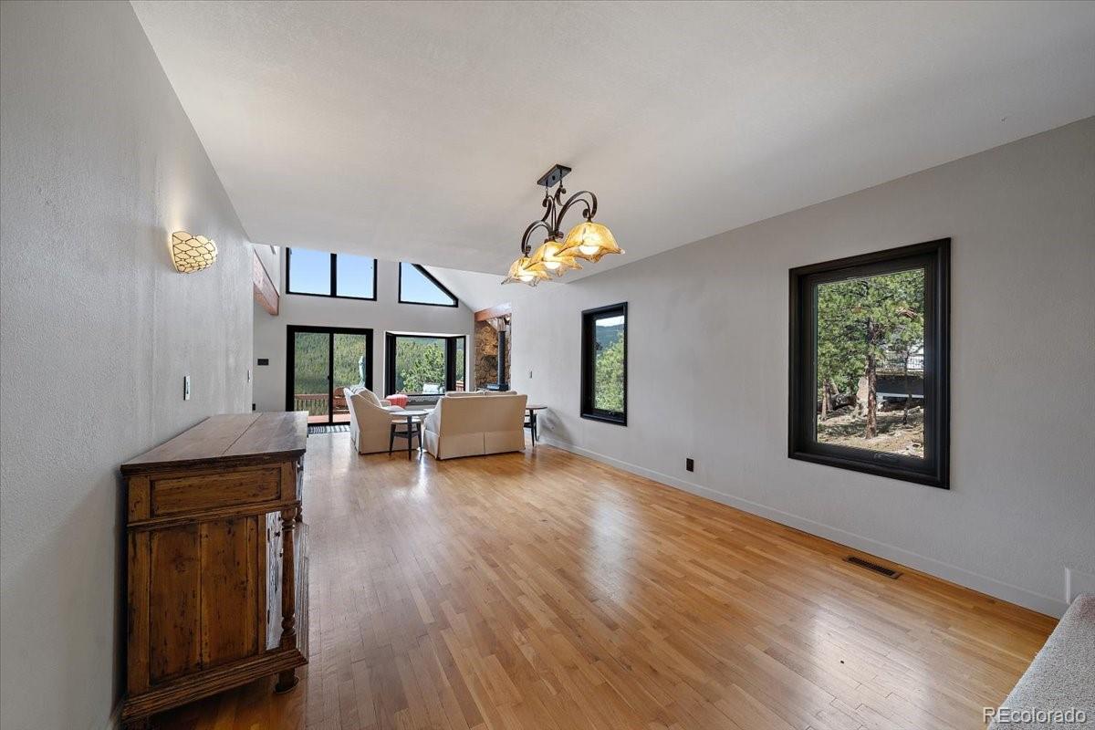 32482 Lodgepole Drive Evergreen, CO 80439 - Photo 3 of 40 a living room with furniture and a table