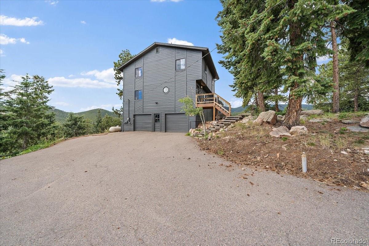 32482 Lodgepole Drive Evergreen, CO 80439 - Photo 34 of 40 a front view of a house with a yard