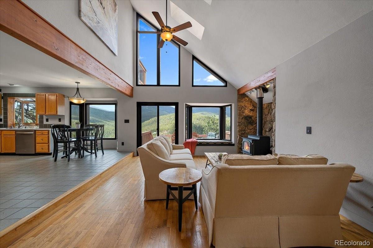 32482 Lodgepole Drive Evergreen, CO 80439 - Photo 4 of 40 a view of a dining room with furniture window and wooden floor