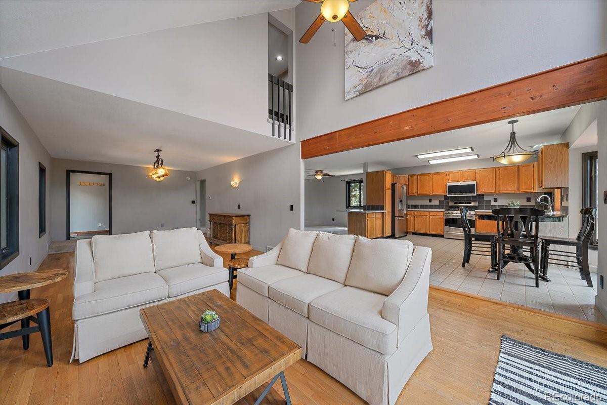 32482 Lodgepole Drive Evergreen, CO 80439 - Photo 6 of 40 a living room with furniture and kitchen view