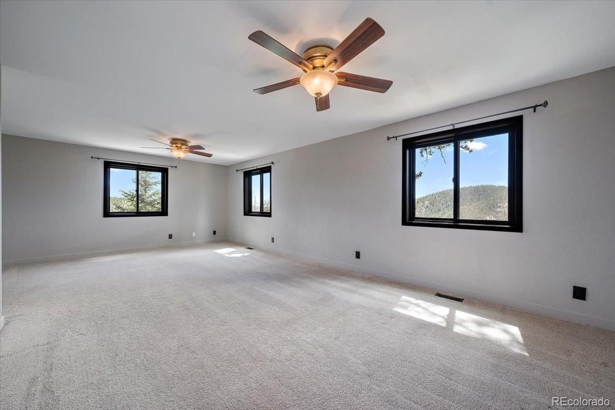 32482 Lodgepole Drive Evergreen, CO 80439 - Photo 9 of 40 a view of an empty room with a window