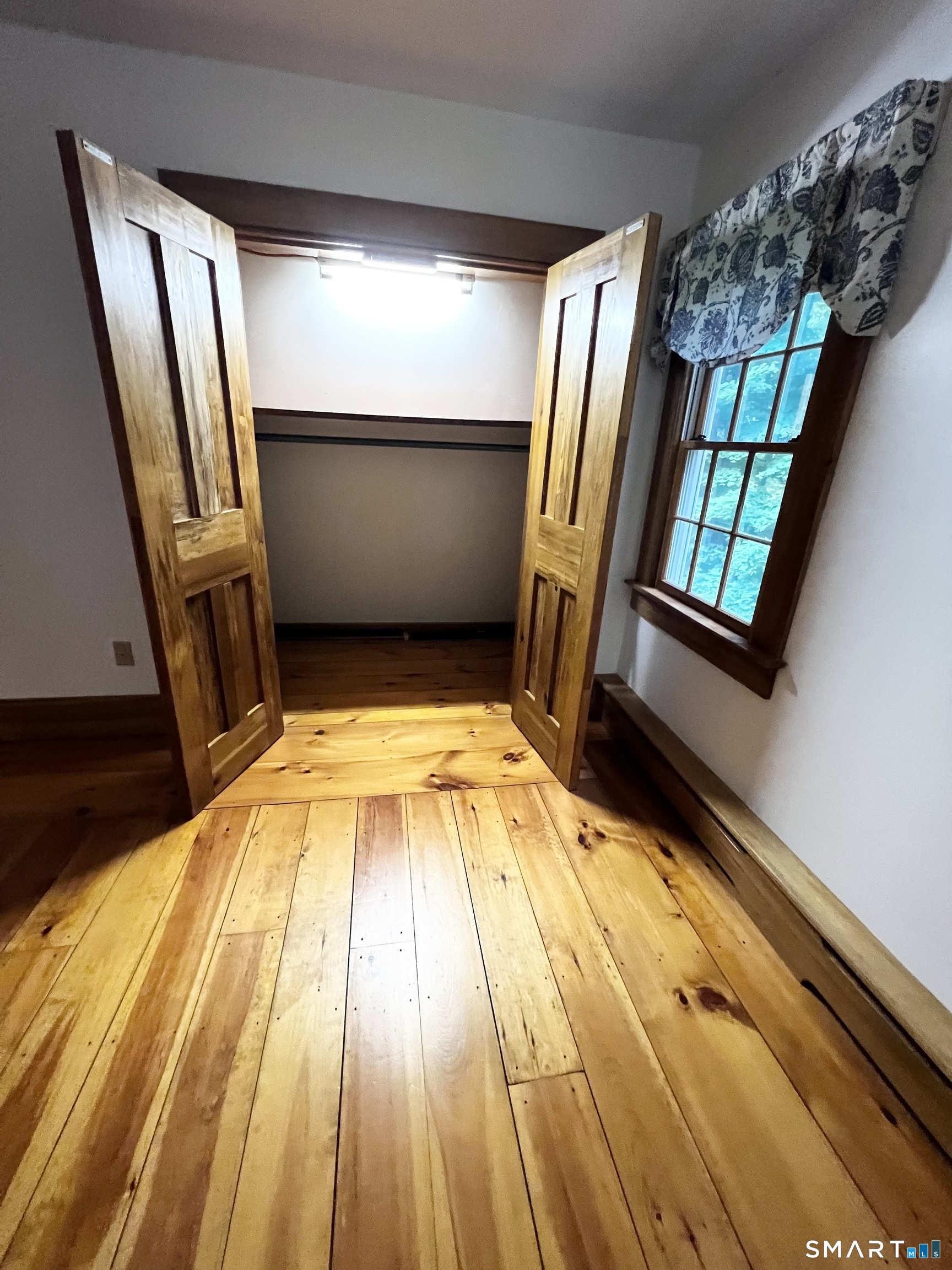 38 Clark Hill Road East Haddam, CT 06423 - Photo 32 of 35 a view of an empty room with wooden floor and staircase
