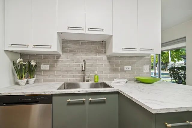 a kitchen with a sink and a wooden floor