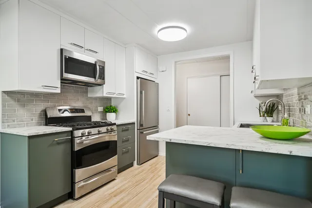 a kitchen with a sink stove and refrigerator