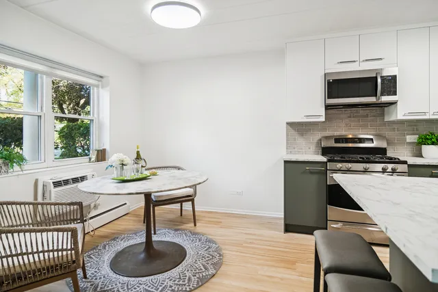 a kitchen with a stove a sink and a microwave