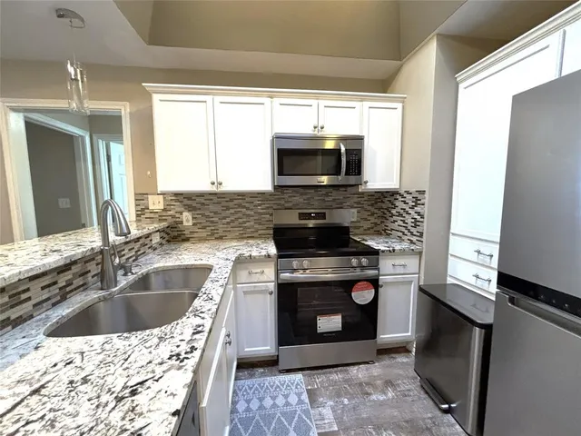 a kitchen with a stove sink and microwave
