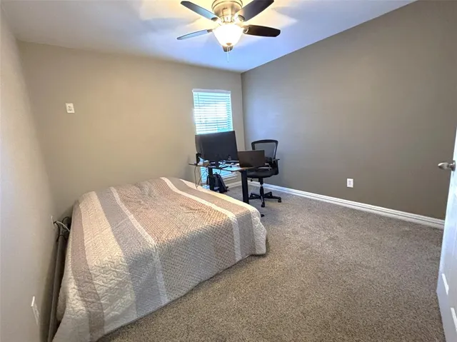 a spacious bedroom with a bed and a chandelier