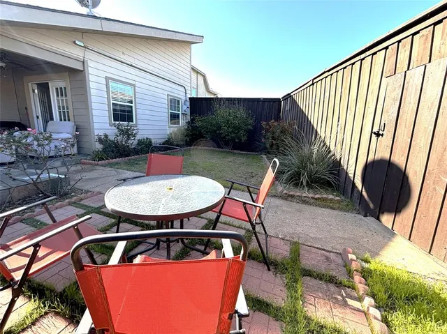 a view of a chairs and table in patio