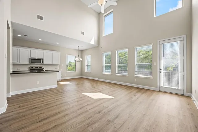 a view of kitchen with wooden floor and electronic appliances