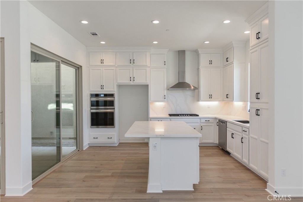162 Pattern Irvine, CA 92618 - Photo 13 of 39 a large kitchen with stainless steel appliances kitchen island granite countertop a large counter top and a stove top oven