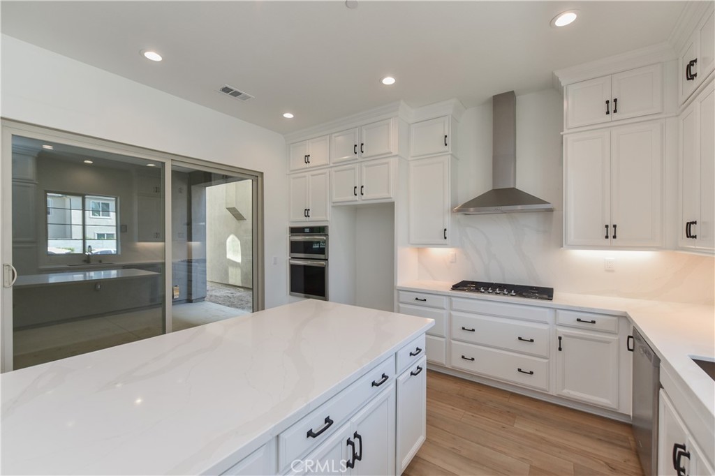 162 Pattern Irvine, CA 92618 - Photo 3 of 39 a kitchen with white cabinets and stainless steel appliances