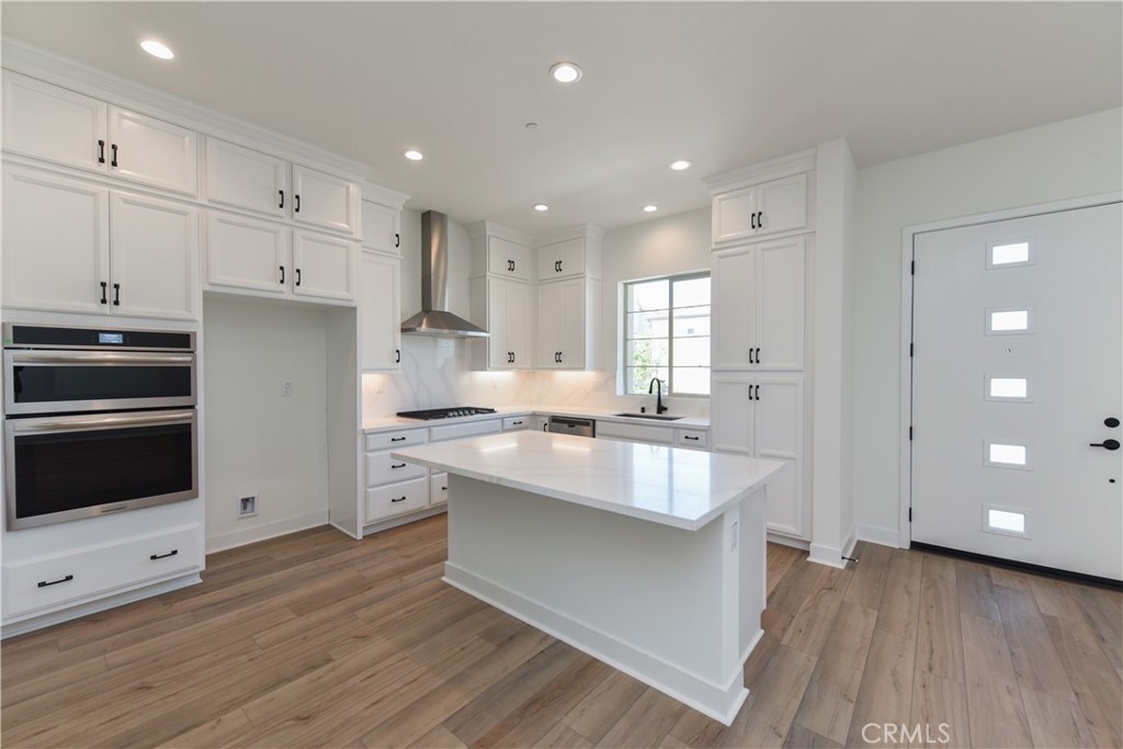 162 Pattern Irvine, CA 92618 - Photo 4 of 39 a large kitchen with cabinets wooden floor and stainless steel appliances