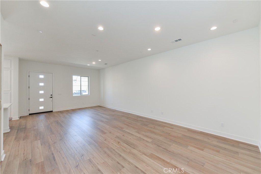 162 Pattern Irvine, CA 92618 - Photo 6 of 39 a view of an empty room with wooden floor and window