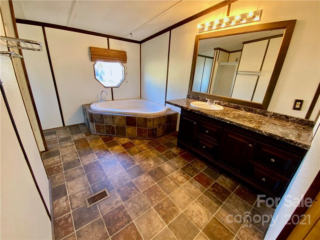 6102 Bill Sain Road Vale, NC 28168 - Photo 3 of 13 a living room with a sink a mirror and rug