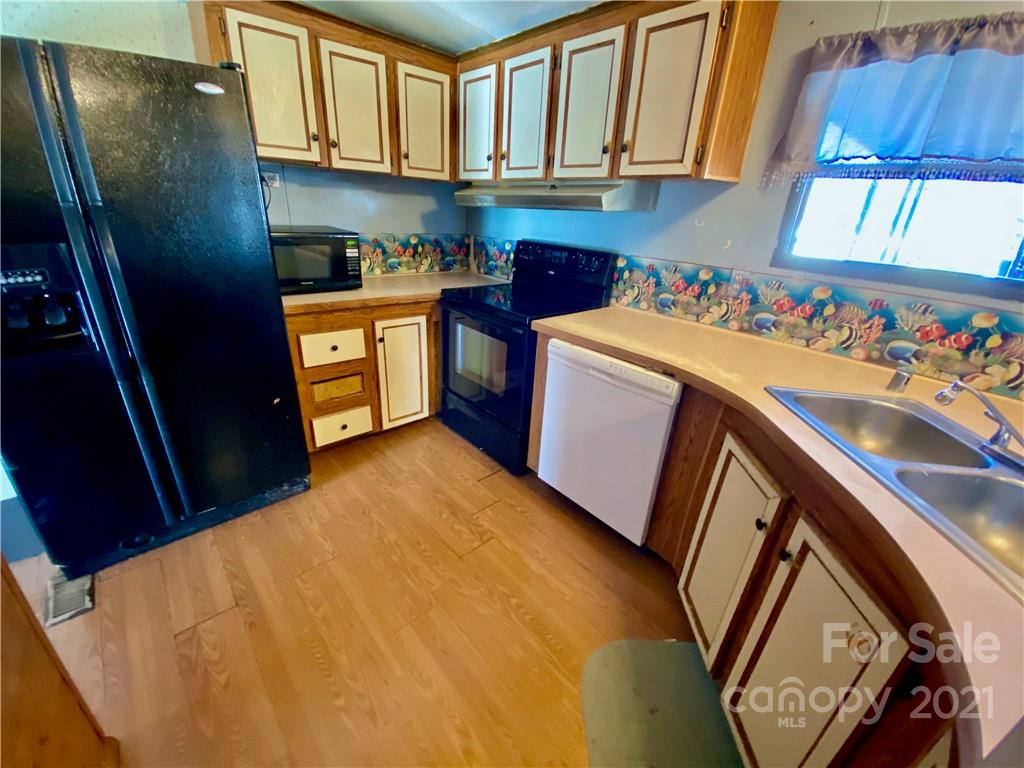 6102 Bill Sain Road Vale, NC 28168 - Photo 5 of 13 a kitchen with stainless steel appliances granite countertop a sink stove and refrigerator