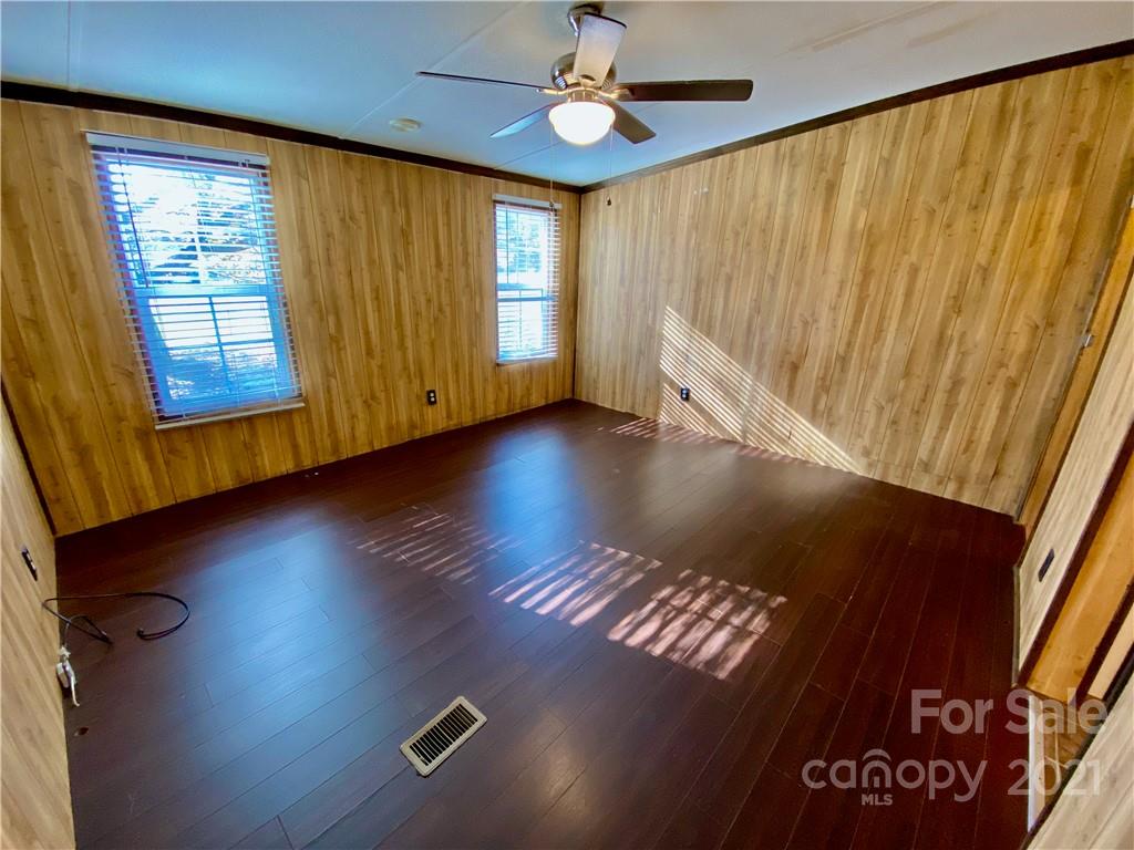 6102 Bill Sain Road Vale, NC 28168 - Photo 6 of 13 a view of empty room with wooden floor and fan