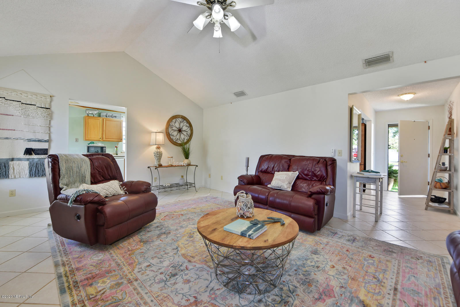 2530 Summer Tree Road East Jacksonville, FL 32246 - Photo 6 of 28 a living room with furniture and a chandelier