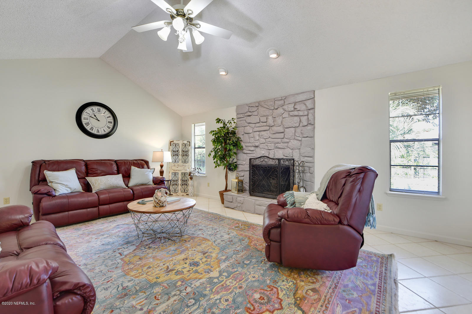 2530 Summer Tree Road East Jacksonville, FL 32246 - Photo 8 of 28 a living room with furniture a fireplace and a large window