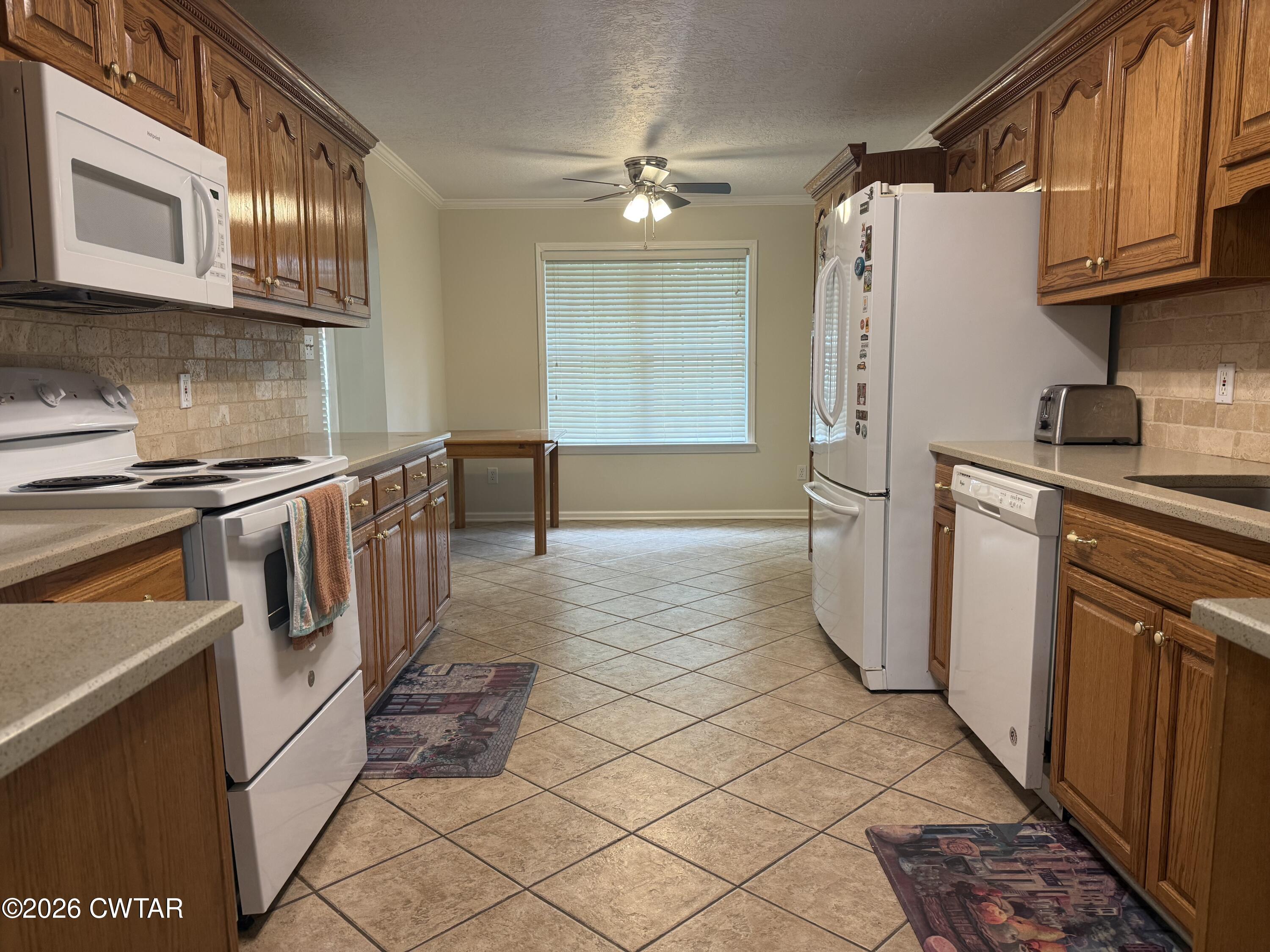 126 Waldunn Cove Rutherford, TN 38369 - Photo 3 of 18 a kitchen with a sink a refrigerator and cabinets
