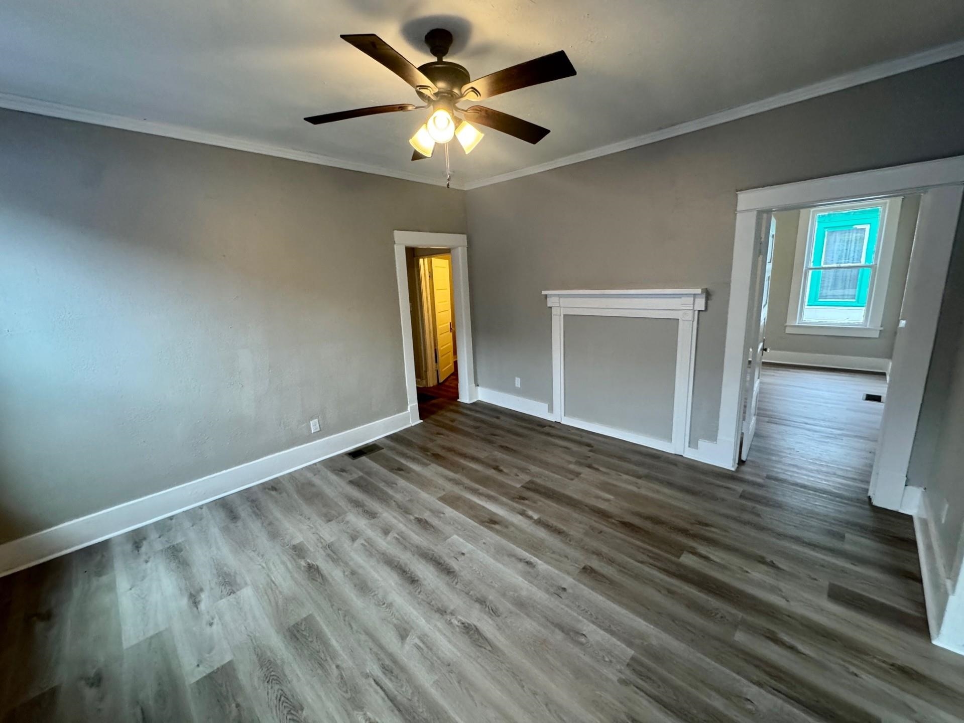 879 Tully Street Memphis, TN 38107 - Photo 12 of 12 wooden floor in an empty room with a window