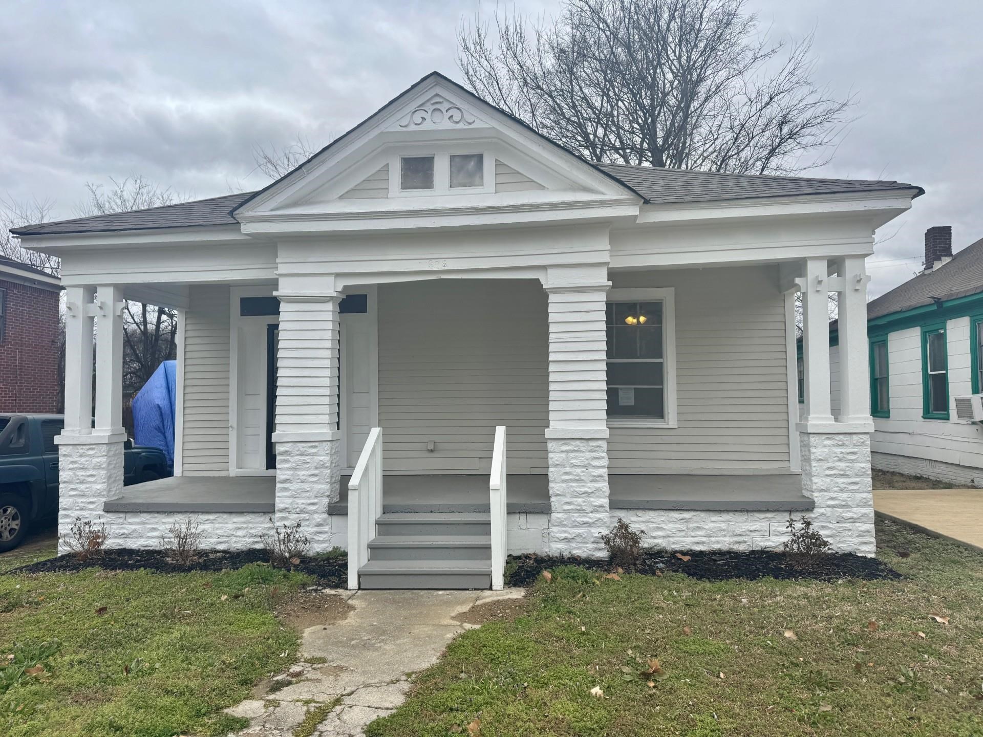 879 Tully Street Memphis, TN 38107 - Photo 2 of 12 a front view of a house with a yard