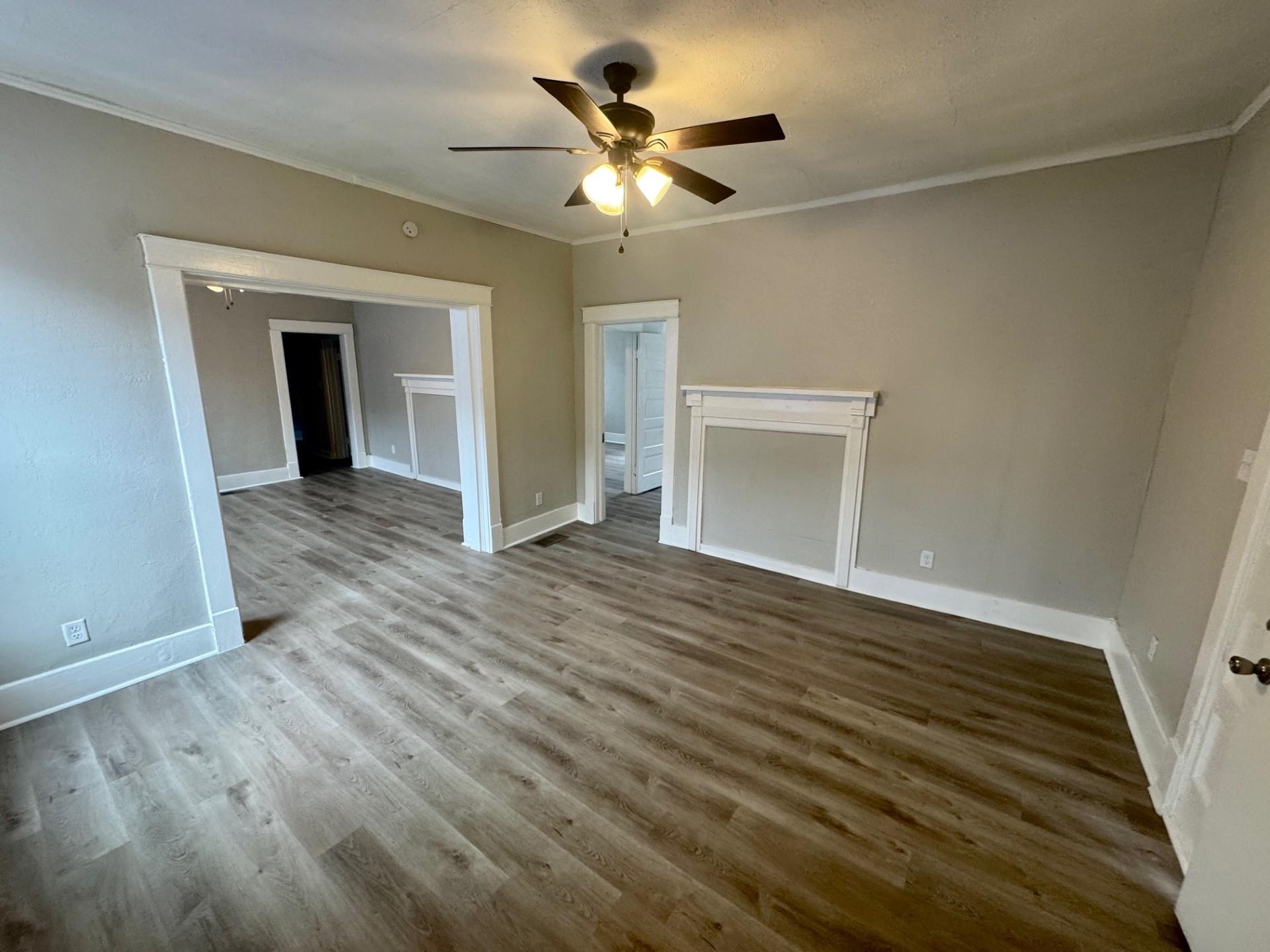 879 Tully Street Memphis, TN 38107 - Photo 8 of 12 wooden floor in an empty room with a window
