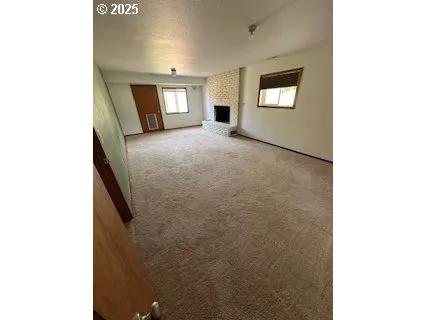 a view of an empty room with windows