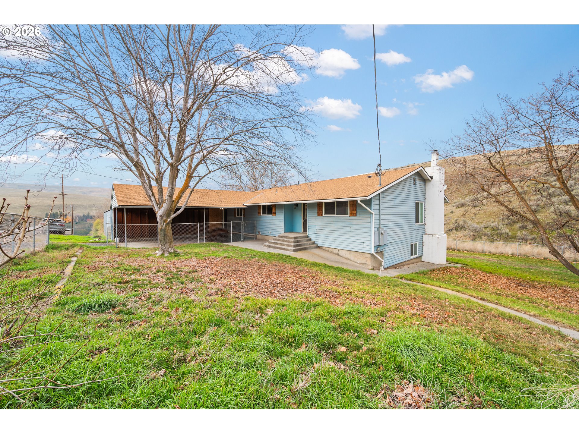 61476 Dee Cox Road Heppner, OR 97836 - Photo 48 of 48 a view of a yard in front of a house with large tree