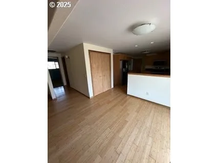 a view of a utility room with closet and wooden floor