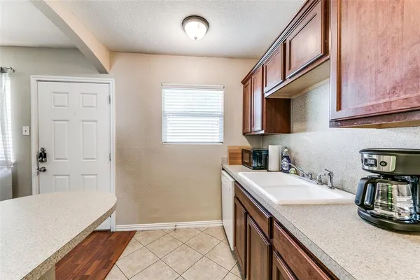 a kitchen with a sink a stove and cabinets