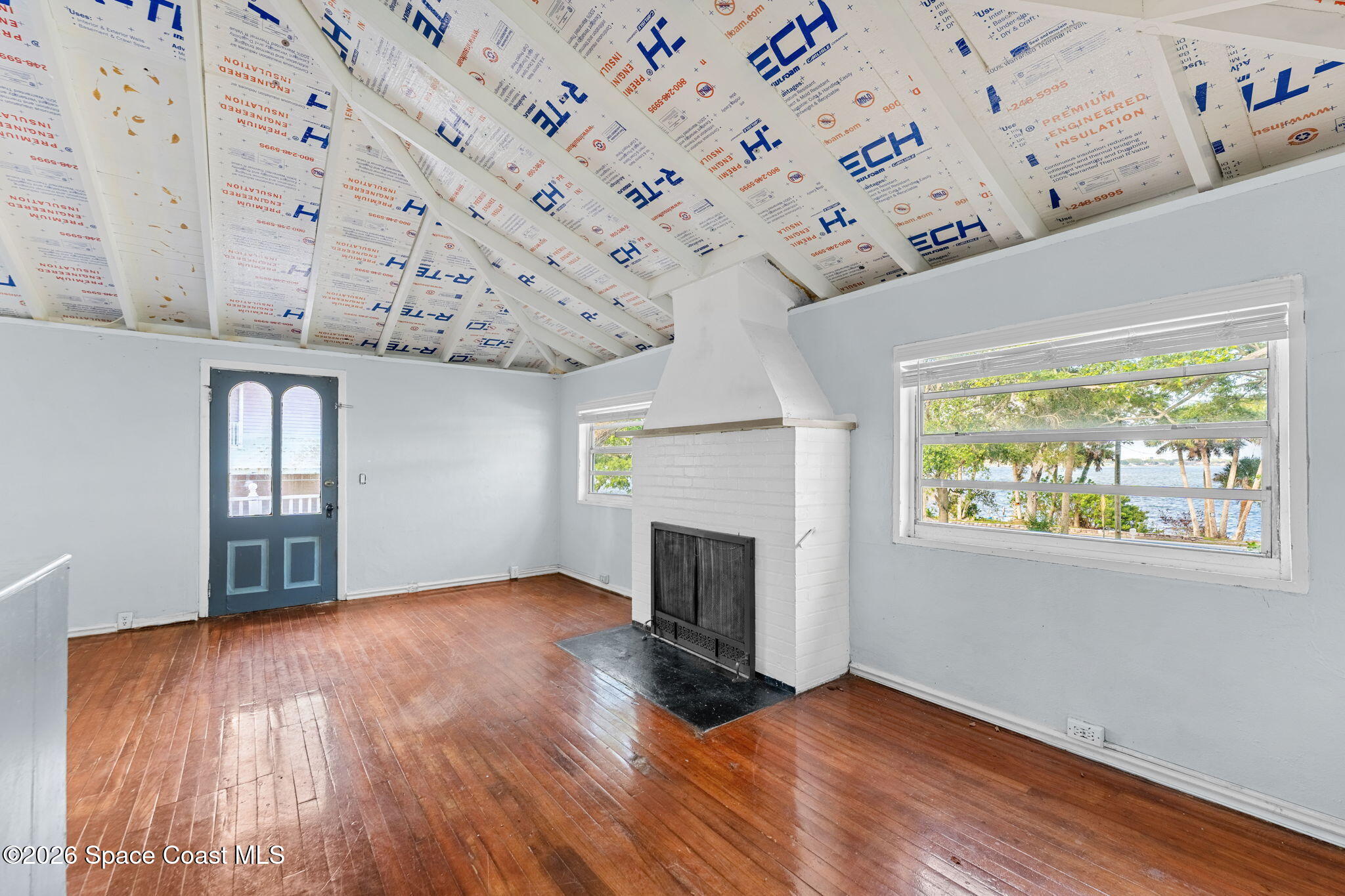 1101 Rockledge Drive Rockledge, FL 32955 - Photo 57 of 76 an empty room with wooden floor fireplace and windows