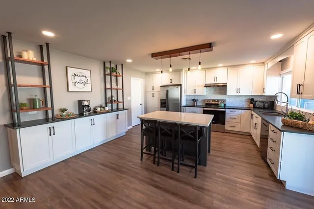 a large kitchen with a table and chairs