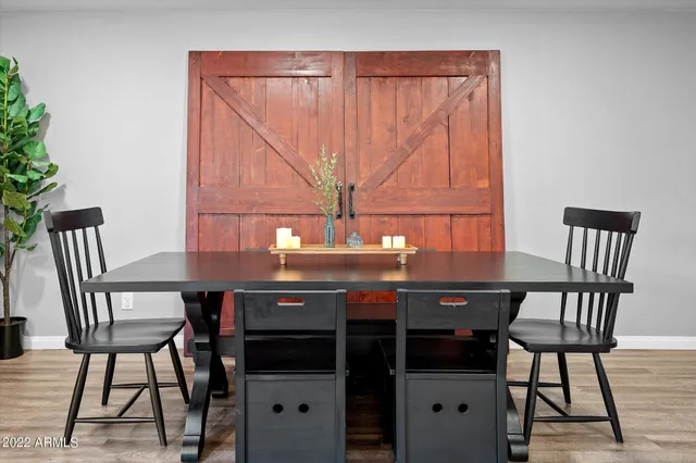 a view of a dining room with furniture and wooden floor