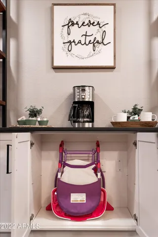 a utility room with a refrigerator and window