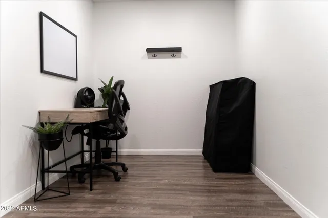 a view of workspace with furniture and wooden floor