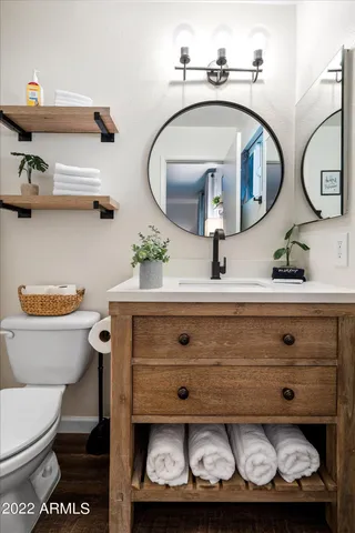 a bathroom with a toilet and a mirror