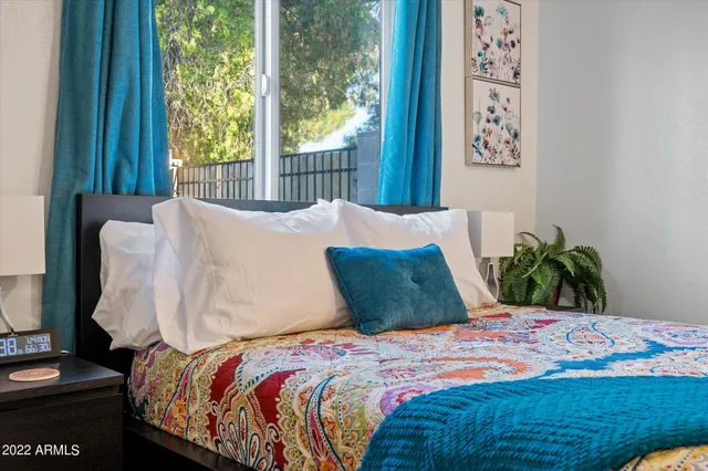 a bedroom with a bed and a window