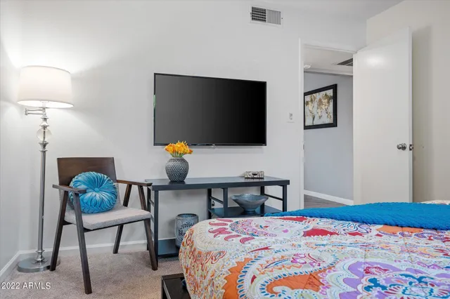 a bedroom with a bed a desk and chair