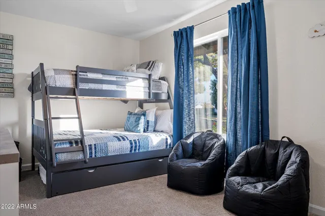 a bedroom with furniture and a window