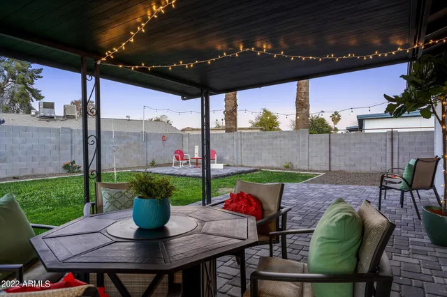 a view of a patio with table and chairs potted plants with wooden floor